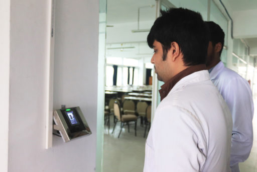 The Student stands before the face regonition device for identity verification at class door